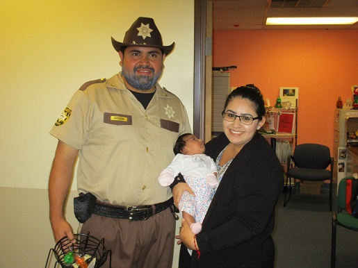 Luis is standing next to Nancy and her baby at the Make it Take it day